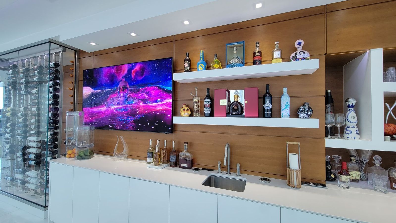 Home bar with TV and LED-backlit wine cabinet display
