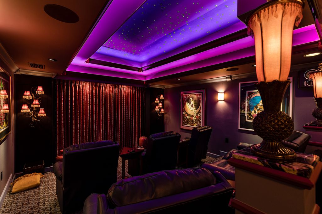 Custom home theater with screen, recessed lighting and theater seating