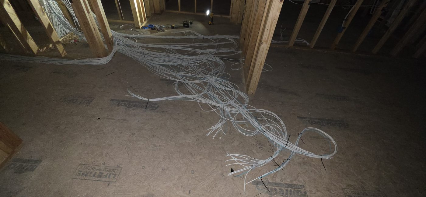 Labeled AV and network cabling home-run to a central panel during construction