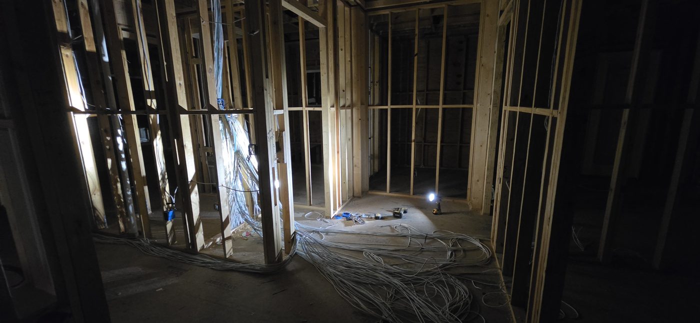 Structured wiring panel with organized low-voltage runs before walls are closed