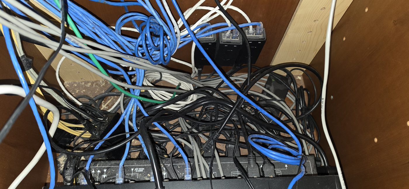 Loose and stretched cables inside a cramped AV cabinet