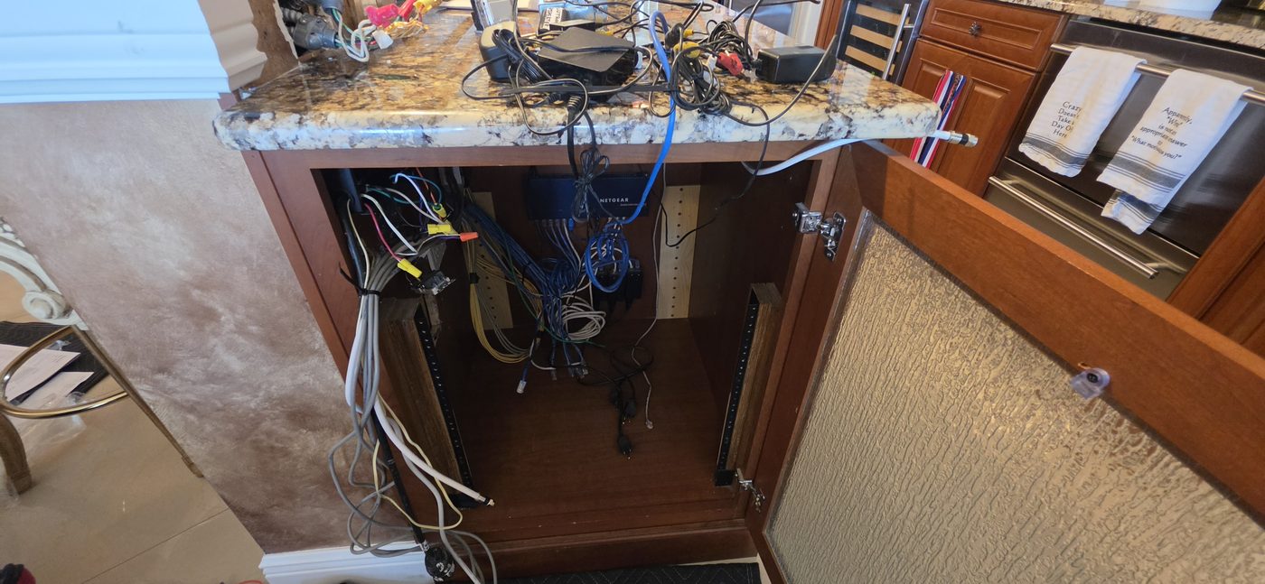 Nest of network and AV wiring before professional cleanup