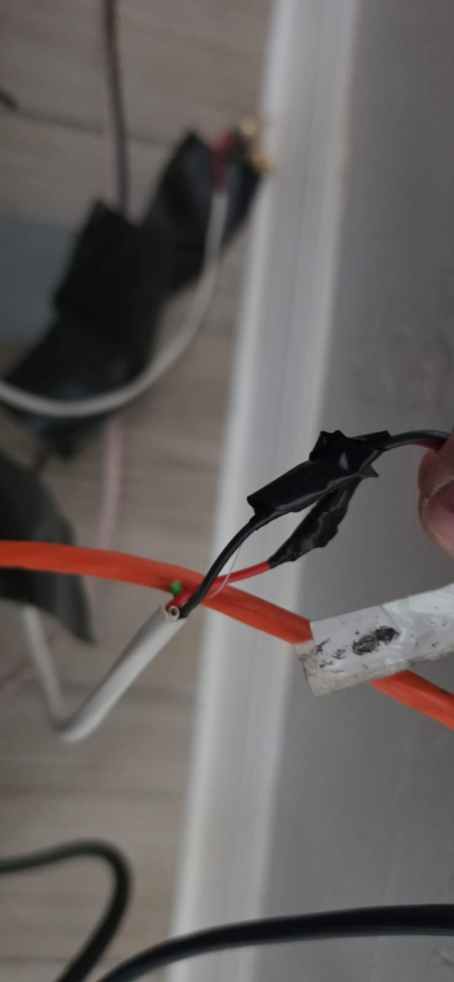 Close-up of an improvised taped wire splice that should be replaced with a proper termination
