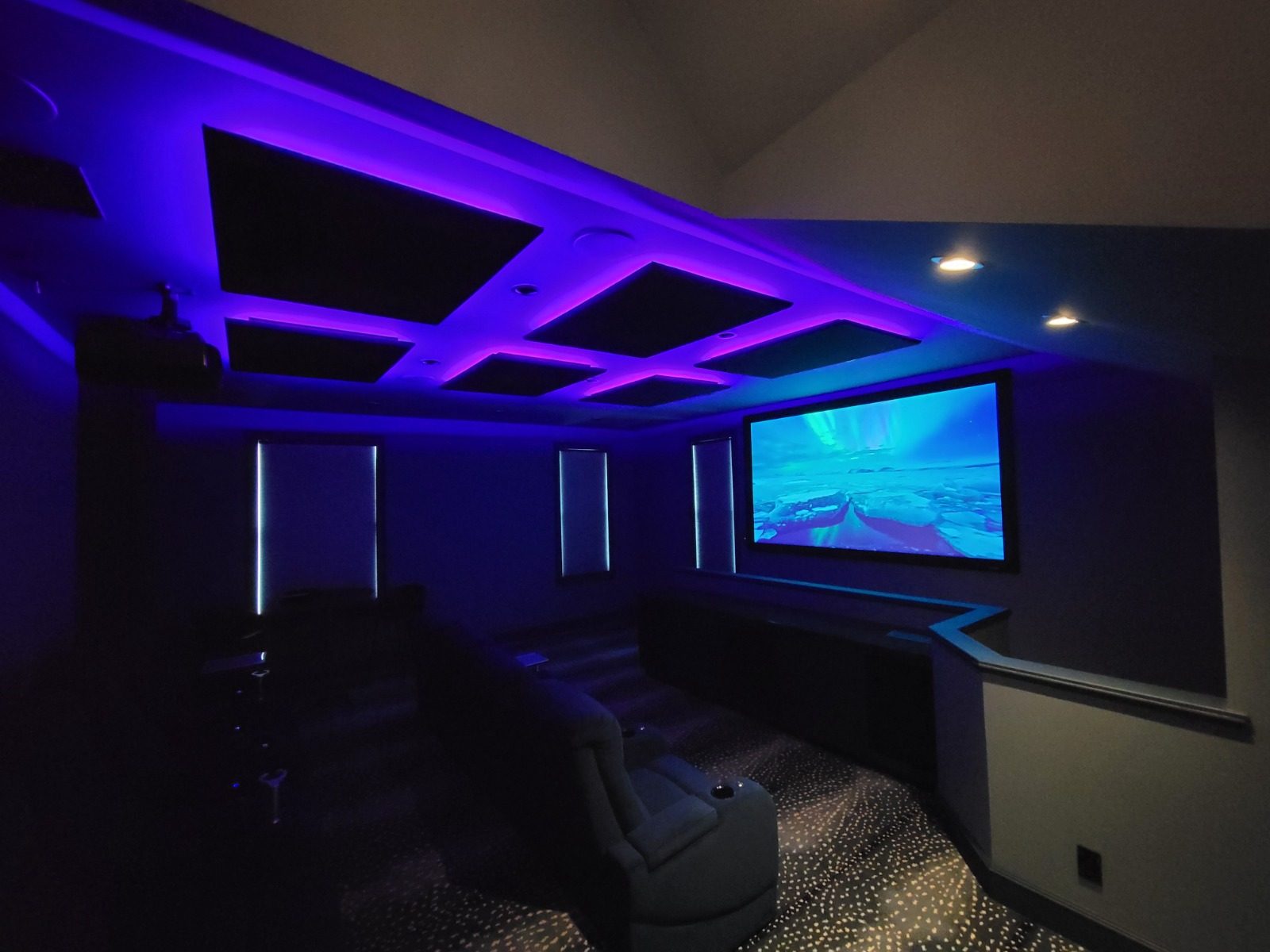 Home theater with purple LED ceiling lighting