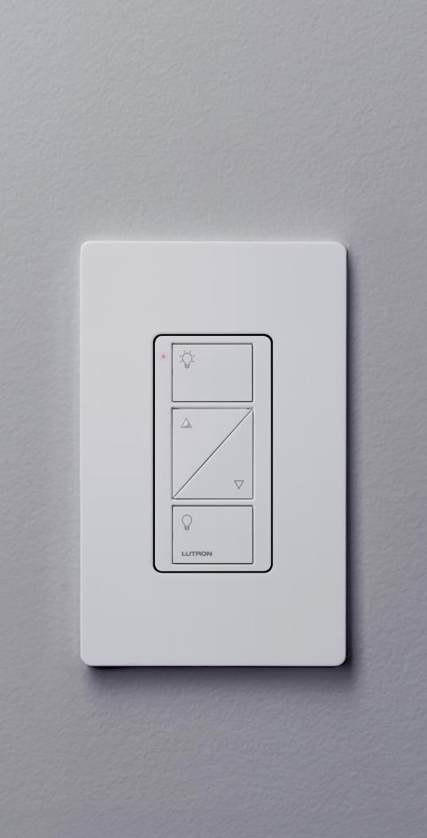 Lutron Caseta white wall dimmer mounted on a clean gray wall