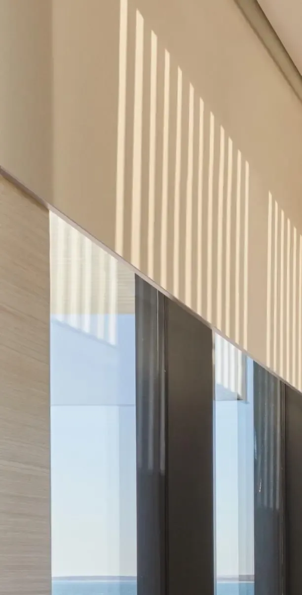 Sunlight streaming through Lutron motorized shades in a warm modern interior