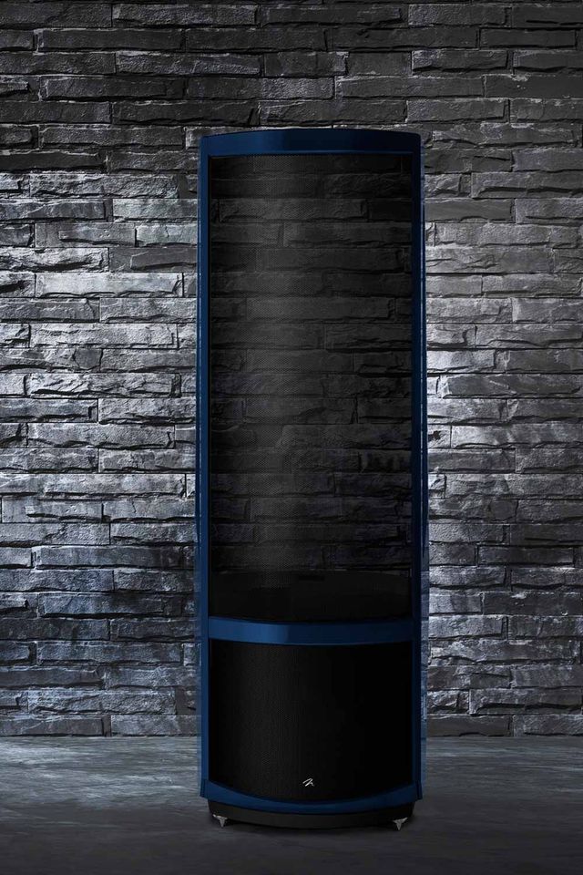 A MartinLogan Masterpiece Series electrostatic speaker in front of a dark stone wall