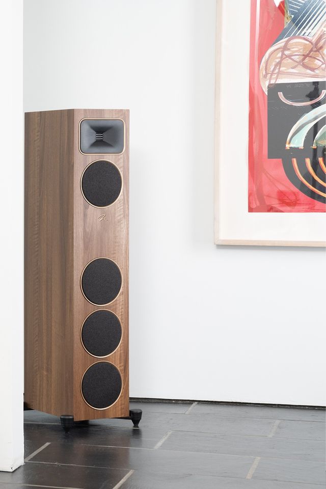 A walnut MartinLogan Motion Foundation floorstanding speaker against a white wall