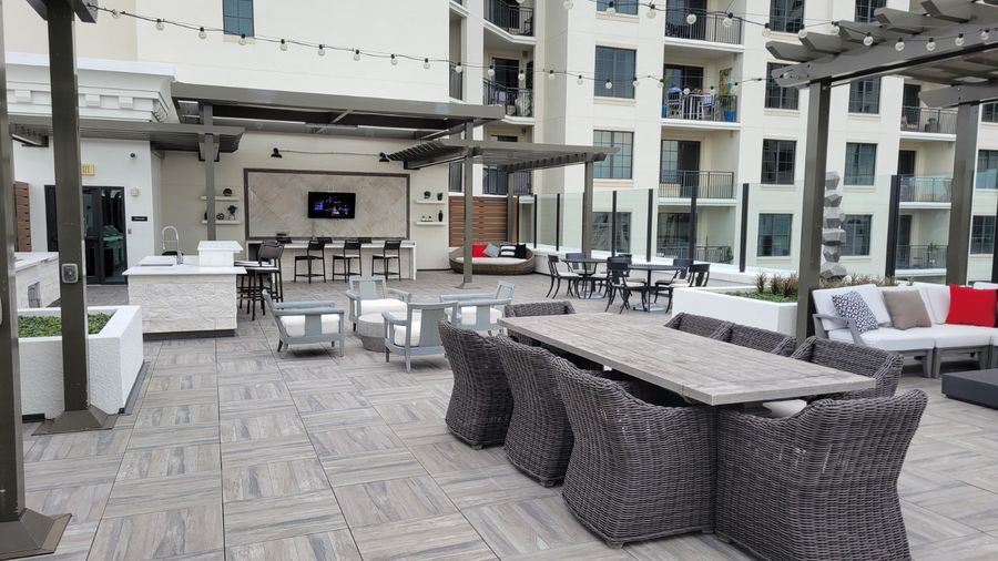 Rooftop dining area with a large outdoor TV